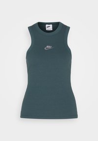 Dark teal ribbed sleeveless Nike tank top with white embroidered logo centered on the chest against a white background.
