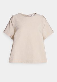 Lyhythihainen beige paita, jossa on pyöreä pääntie, teksturoitu kangas ja hillitty kiilto sekä siro takana oleva vetoketju.