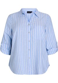 Camicia azzurra chiara con righe bianche verticali, dotata di taschino, maniche arrotolabili e taglio rilassato. Tessuto intrecciato.