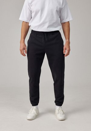 SNOCKS Pantaloni sportivi - schwarz
