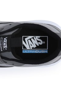 Gray Vans sneaker featuring a mesh upper, black accents, and an Ultracrush insole logo. Smooth texture with a rounded toe and flat sole.