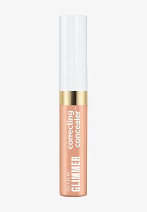 Correcteur Revlon Glimmer en teinte pêche avec un capuchon blanc et une bande dorée, posé verticalement sur un fond blanc.