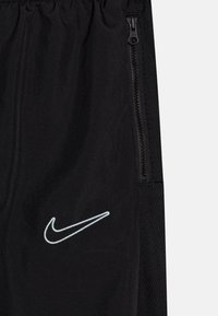 Nike Performance ACADEMY 23 TRACK PANT UNISEX - Spodnji deli trenirk - black/glacier blue