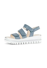 Blue suede sandal featuring three adjustable straps, a cushioned insole, and a chunky white sole with silver accents.