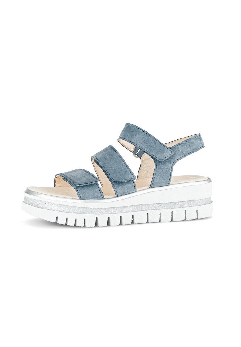 Blue suede sandal featuring three adjustable straps, a cushioned insole, and a chunky white sole with silver accents.
