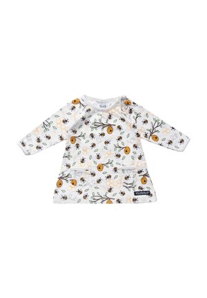 Witte jurk met lange mouwen voor peuters, bedrukt met bijen, honingraten, takken en groene bladeren, met twee zakken aan de voorkant en een "Villervalla" label.