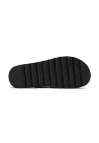 Black rubber shoe sole with a flat, ridged design. It features seven horizontal grooves for grip and a rounded toe for comfort.