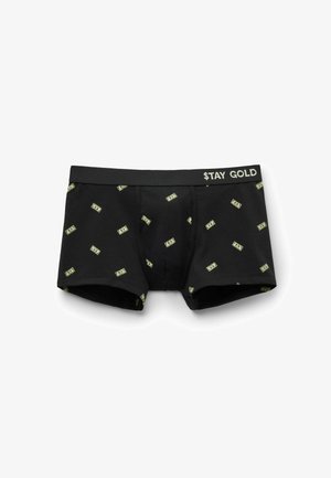 Schwarze Boxershorts mit einem Muster aus Geldscheinen in Grün und Gelb. Der Bund trägt den weißen Schriftzug "$TAY GOLD". Weiche Textur.