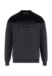 Schwarzer Pullover mit einfarbigem Design und kontrastierendem strukturiertem Einsatz, auf der Brust mit "GUESS EST. 1981" versehen.