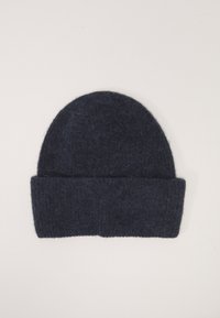 Bonnet en laine bleu marine avec une finition douce et texturée et un revers replié en bas, présentant une forme de sommet arrondi simple.