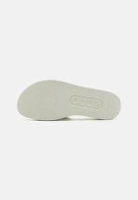 White rubber shoe sole with textured surface, featuring embossed logo and size markings. Rounded shape with slight arch.