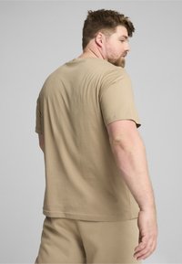Beige short-sleeve t-shirt, relaxed fit, cotton fabric, round neckline, smooth texture, paired with matching beige shorts.