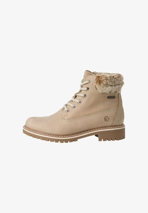 Bottes mi-mollet beiges avec bord en fausse fourrure, bout rond et design à lacets. Présentent un dessus texturé et une semelle en caoutchouc durable avec une bonne adhérence.