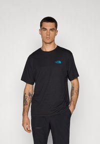 Black short-sleeve T-shirt made of cotton blend, featuring a blue logo on the chest. Simple design with a crew neck and relaxed fit.