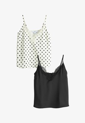 Two women's sleeveless tops, one white with black polka dots and lace trim, the other solid black with lace trim at the neckline.