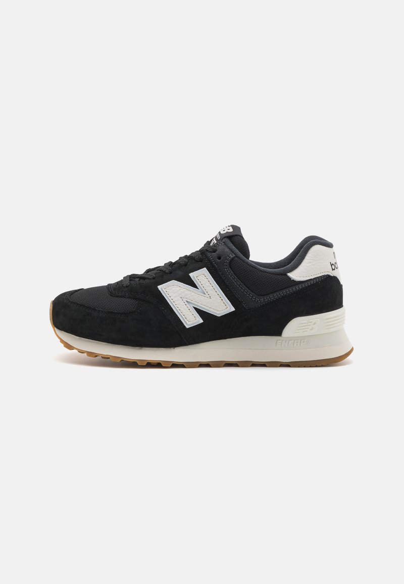 Black suede and mesh sneaker with a white "N" logo, beige midsole, and gum rubber outsole; low-profile, lace-up design.