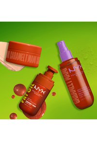 Three NYX Professional Makeup products in orange packaging labeled Caramelt Mami on a green background with liquid splashes.