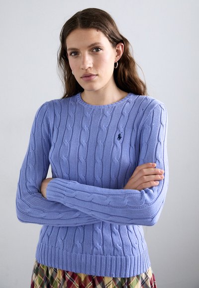 Light purple cable-knit sweater with ribbed cuffs and hem, featuring a small embroidered logo on the chest. Soft texture and fitted design.