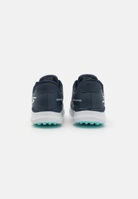 Navy athletic shoes featuring a textured upper, white midsole, and turquoise outsole, with a logo on the heel and minimalistic design elements.