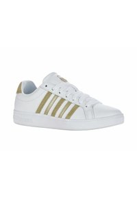 White athletic sneakers with three gold stripes, round toe, textured rubber sole, and lace-up design. Soft fabric interior lining.