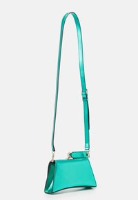 Emerald green metallic handbag with a structured shape, adjustable strap, and sleek lines. Features a glossy finish and minimal hardware.