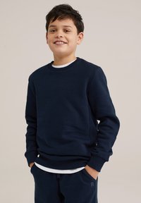 Navy blue sweatshirt, crew neck, long sleeves, ribbed cuffs, cotton blend fabric with a smooth texture, paired with a white undershirt.
