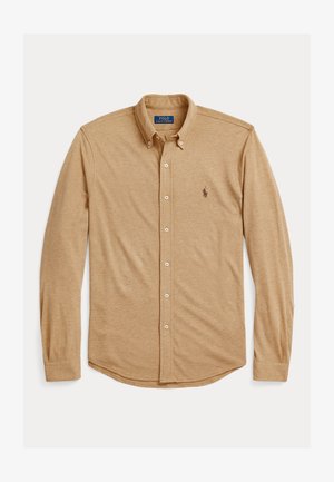 Gari ilgi piedurkņu krekli tan krāsā, izgatavots no mīksta auduma. Iespējots klasiskā apkakle, pogu aizdare un neliels logotips uz krūškurvja.