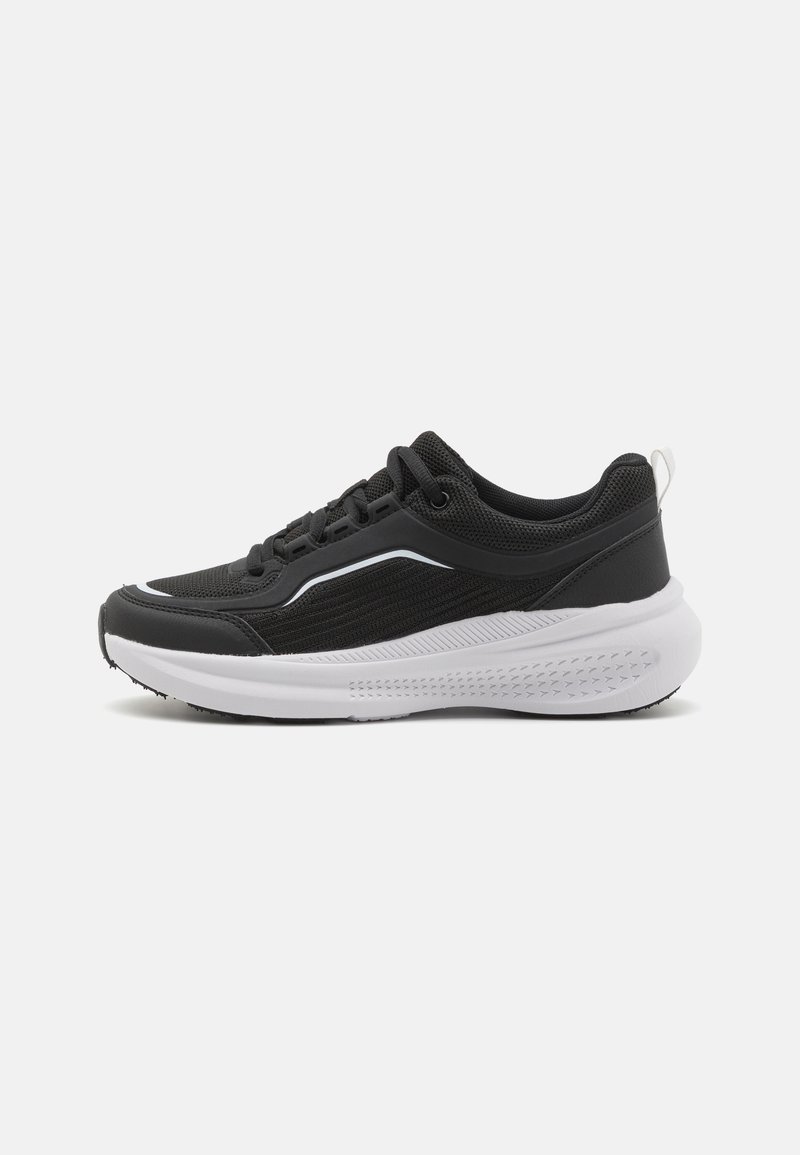 Black athletic sneakers with mesh upper, white midsole, and textured black outsole. Features lacing system and small white accent on heel.
