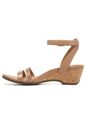 Wedge sandal featuring a cork heel, nude textured straps, and an adjustable ankle strap for a secure fit. Smooth, matte footbed.