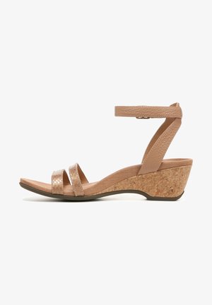 Wedge sandal featuring a cork heel, nude textured straps, and an adjustable ankle strap for a secure fit. Smooth, matte footbed.