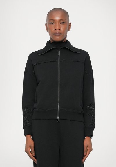 Black zip-up sweatshirt with a high collar and beaded floral details on sleeves. Made of soft fabric with ribbed cuffs and hem. Plain back.