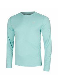 Maglietta sportiva a maniche lunghe di colore azzurro chiaro, realizzata in un tessuto liscio e elasticizzato. Presenta un collo a giro e una marca minimalista sul petto.
