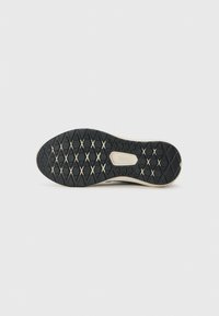 Black rubber shoe sole with a diamond-patterned tread and a cream-colored edge; features a brand logo in the center.
