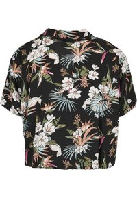 Camisa negra de manga corta con un ajuste relajado. Presenta flores blancas y rosas, hojas verdes y acentos tropicales en un diseño vibrante.