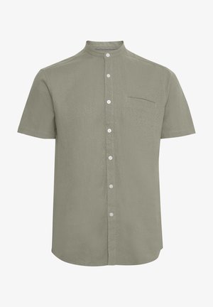 Camicia a maniche corte con colletto in verde oliva chiaro. Presenta una chiusura con bottoni, una tasca sul petto e un tessuto testurizzato.