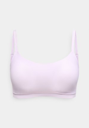 Sutien wireless fără cusături, de culoare mov deschis, cu bretele subțiri reglabile și material neted, prezentat pe un fundal simplu gri deschis.