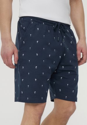 Pantaloni corti blu navy in cotone, con un motivo di palme bianche, dotati di vita elastica e cordoncino regolabile.