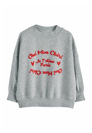 Sweat-shirt gris clair avec texte rouge en français « Oui Mon Chéri Je T'Aime Paris » et symboles de cœur à l'avant, poignets et ourlet côtelés.
