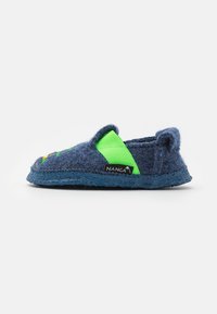 Blue felt slipper with a green elastic strap, rounded toe, textured sole, and NANGA branding. Pairs bright colors with a soft material.