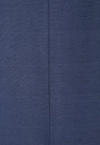 Tmavě modrá látka s hladkou texturou, která má jemný žebrovaný vzor. V centru je viditelný šev, který naznačuje možné sestavení oděvu.