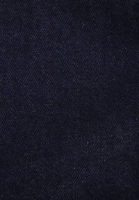 Dark blue denim fabric with a smooth, even texture, featuring a subtle sheen and minimal variations in color. No distinctive patterns or hardware.