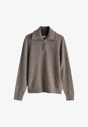 Ruskea vetoketjullinen neulepusero, jossa on resorikaulus ja -hihansuut. Pehmeä rakenne, löysä istuvuus ja vähäiset sauma-aukot.