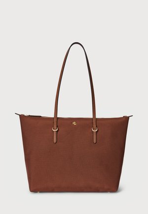 Brown tote bag in textured fabric with gold-tone hardware, dual handles, and a zipper closure. Simple design with a logo accent.