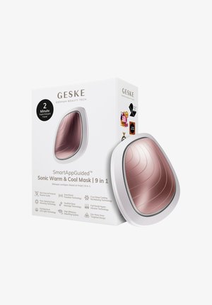 Masque Sonic Chaud & Froid 9-en-1 GESKE SmartApp guidé avec surface courbée en or rose, à côté de sa boîte d'emballage blanche.