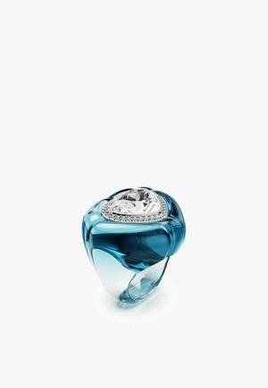 Heart-shaped ring with a clear gemstone centerpiece, surrounded by small clear stones, set on an aqua blue, glossy band.