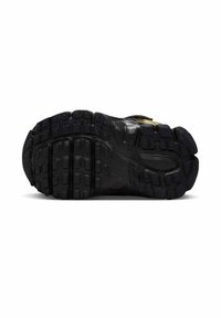 Czarna gumowa podeszwa z fakturowanym wzorem bieżnika, pokazująca rowki i wypustki zapewniające przyczepność; wzmocnione sekcje w okolicach pięty i palców.