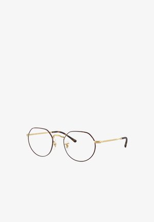 Occhiali rotondi con sottile montatura in metallo dorato e dettagli in tartaruga. Lenti trasparenti e naselli regolabili. Aste sottili per il comfort.