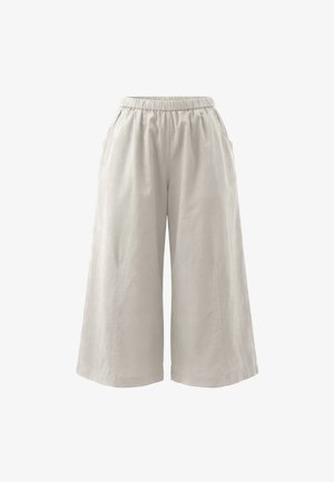 Løse lysebeige vide bukser med elastisk talje og sidelommer, vist på hvid baggrund.