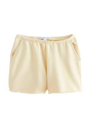 Perzikkleurige shorts met een elastische tailleband, twee zijzakken en een gladde, lichte stof. Geen zichtbare patronen of hardware.