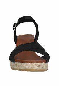 Black fabric wedge sandal with crossed straps, brown footbed, jute-wrapped heel, and a buckle closure at the ankle for secure fit.
